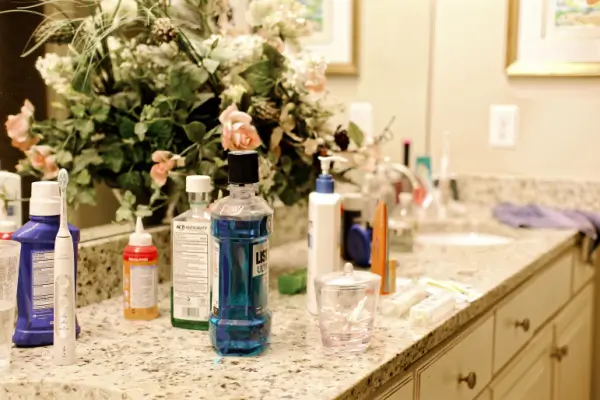 Clutter of products on the bathroom counter.
