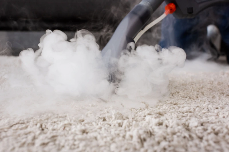 Steam cleaning carpet.