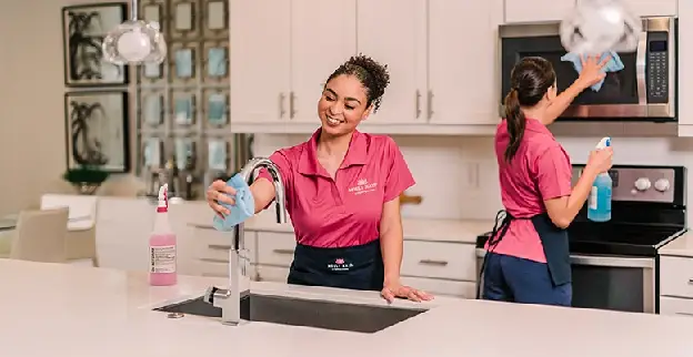 Molly Maid service professionals cleaning a kitchen after a home remodel.