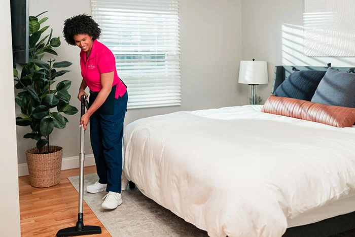 A Molly Maid professional wiping a counter during a commercial recurring cleaning appointment .