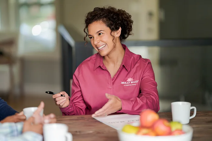 A Molly Maid professional explaining commercial cleaning options to clients.