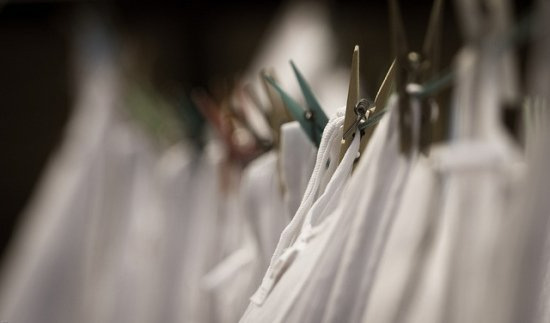 White clothing pinned by clothespins to a clothesline. Photo Credit: Lennart Tange on Flickr.