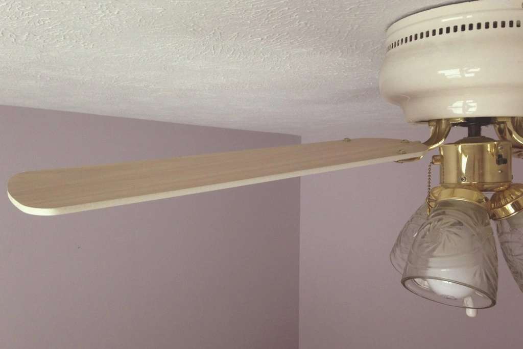 A ceiling fan blade without any dust on top.