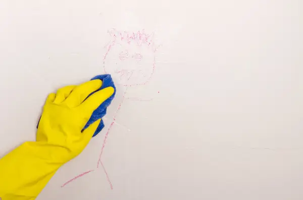 Person scrubbing flat paint walls