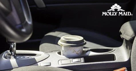 A coffee cup in the cup holder of a car