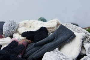 A pile of winter hats and gloves