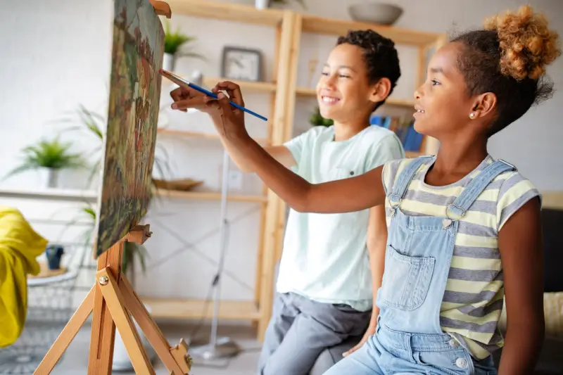 Two kids painting in their living room.