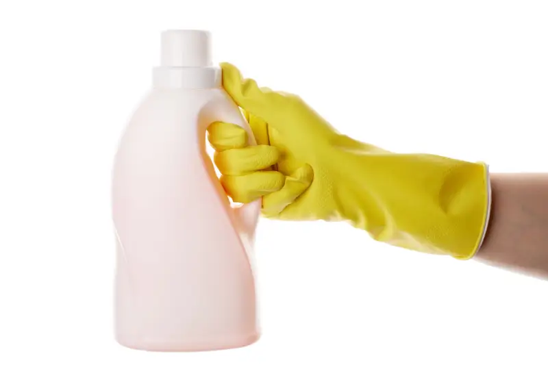 Person holding bleach for carpet stain removal