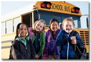 Children standing outside of school bus