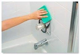 photo of person cleaning bathroom with sponge