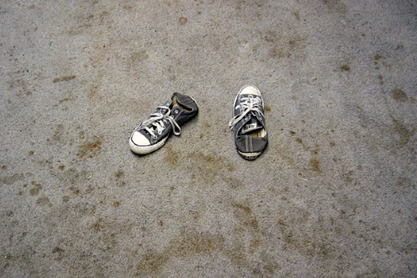 A pair of shoes on dirty, stained carpet. Photo: Dong Jun on Flickr.