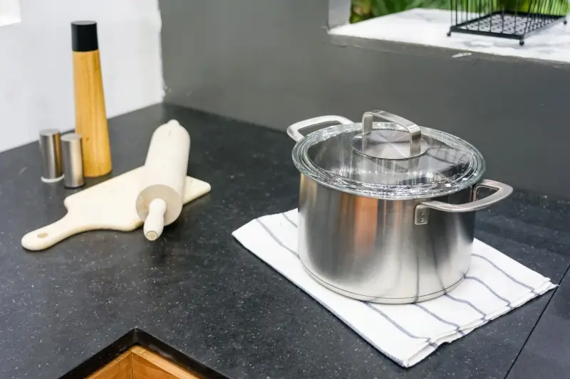 Stainless steel pot on granite counter top with heat protection