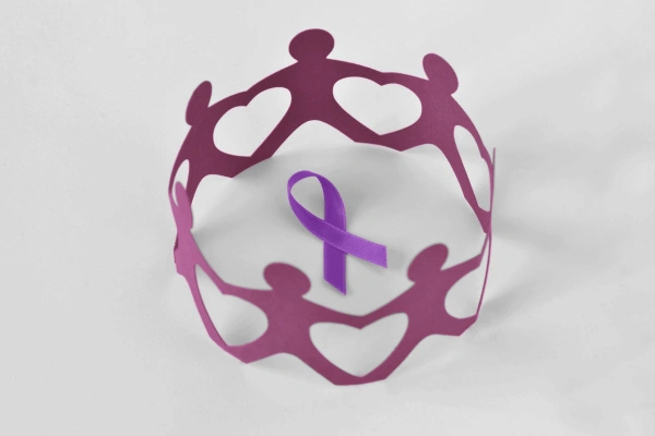 Paper people in a circle around violet ribbon