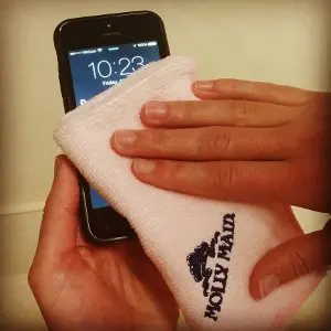 cloth wiping a phone screen'