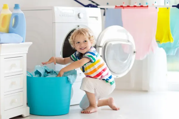 Kid helping with family chores in the laundry room