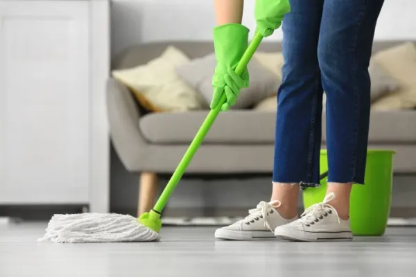 Woman mopping the floor in her living room