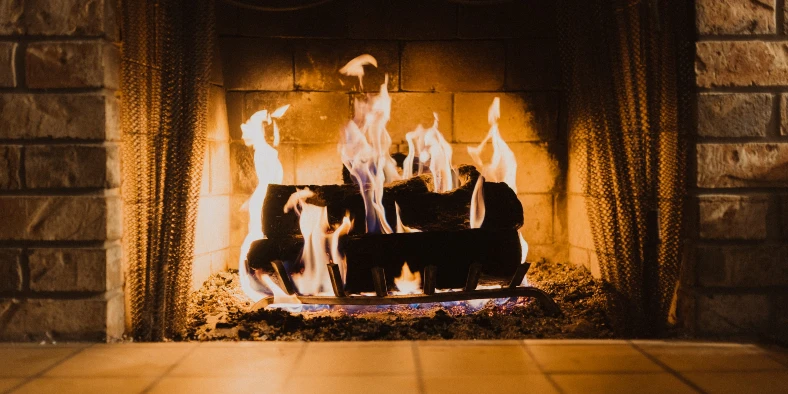 Fire in a fireplace, photo by Hayden Scott on Unsplash