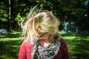 Woman shaking her hair free of glitter