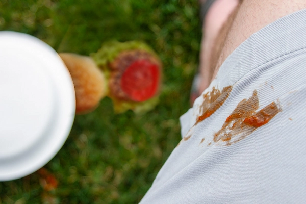 Close-up of ketchup stain on white shorts.
