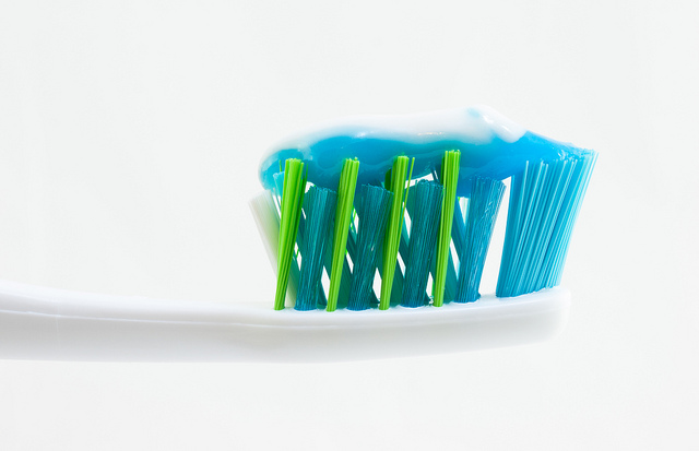 A toothbrush with toothpaste on it. Photo Cred: William Warby on Flickr.