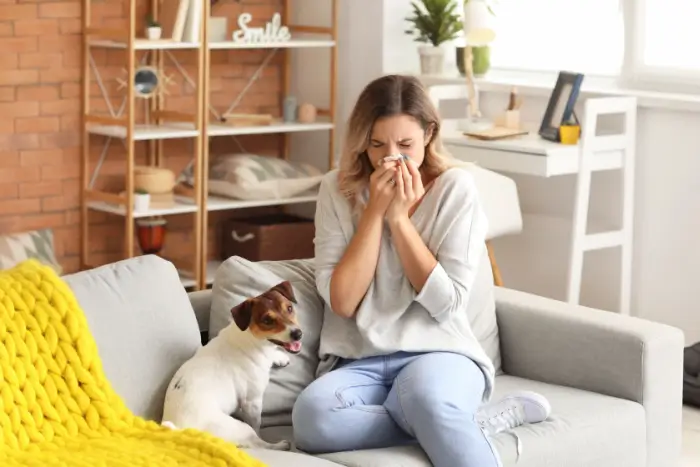 Woman blowing her nose from allergens in her home
