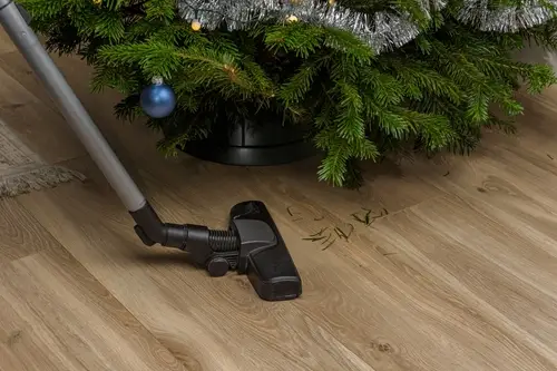 Woman cleaning a table decorated for Christmas.