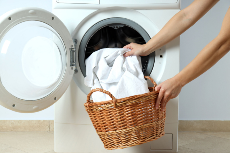 Person taking comforter out of washing machine