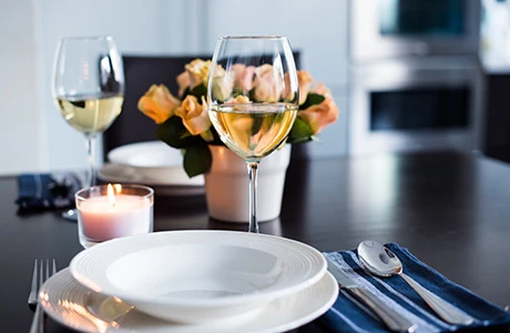 table setting with wine glasses and plates.