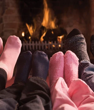 Family warming feet on the fireplace