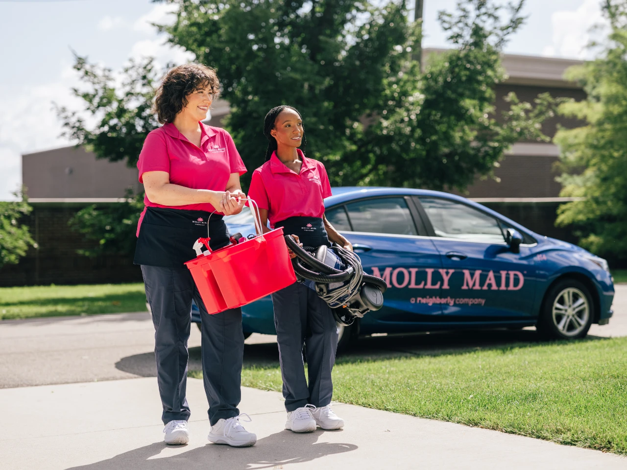 Happy Molly Maid employees at a customer's home.