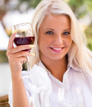 woman holding a glass of red wine