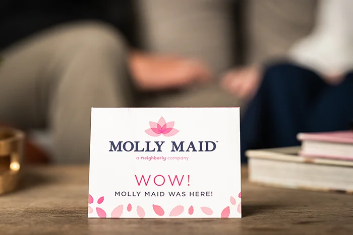 A Molly Maid card left on a table after an eco-friendly cleaning. 