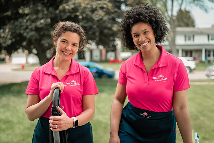Molly Maid professionals outside smiling before performing residential cleaning services.