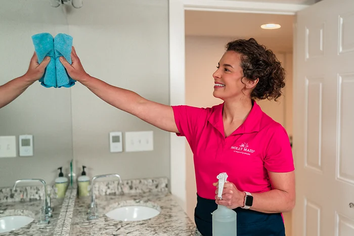 A Molly Maid professional providing home cleaning service.