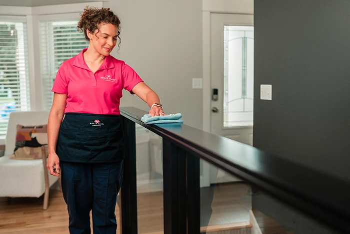 A Molly Maid professional providing home cleaning service.