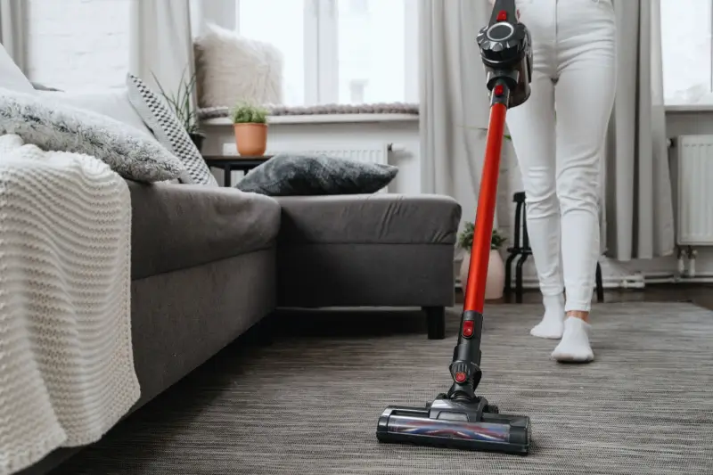 Woman vacuuming her living room
