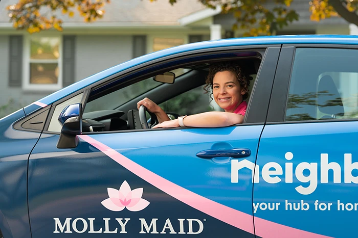 A Molly Maid professional on her way to a spring cleaning service.